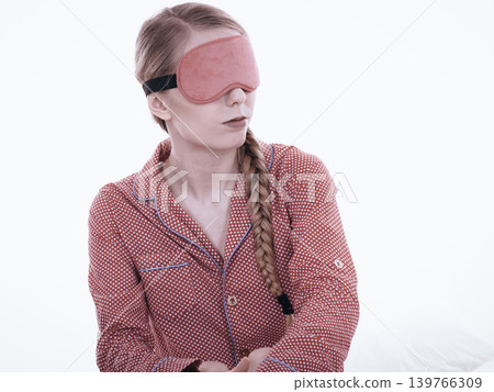 Sleepy woman wearing pink eye band Sleepy woman wearing pink eye band 139766309