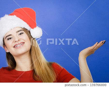 Positive woman wearing Santa Claus helper costume Positive woman wearing Santa Claus helper costume 139766800