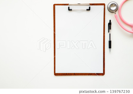 Image of a medical interview: A binder with blank paper inside and a stethoscope. Image of a medical interview: A binder with blank paper inside and a stethoscope. 139767230