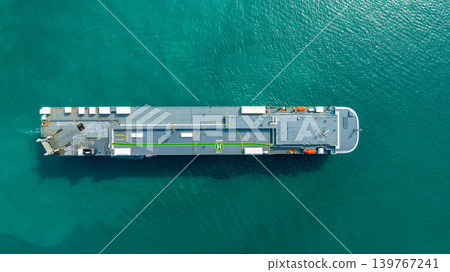 Aerial top view vehicles carrier on sea, Ro Ro (Roll on Roll off) automobile carrier vessel international car terminal, Automobile industry distribution logistic transport new car. Aerial top view vehicles carrier on sea, Ro Ro (Roll on Roll off) automobile carrier vessel international car terminal, Automobile industry distribution logistic transport new car. 139767241