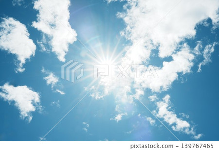 White clouds spread across a vibrant blue sky, bathed in the dazzling sunlight. White clouds spread across a vibrant blue sky, bathed in the dazzling sunlight. 139767465