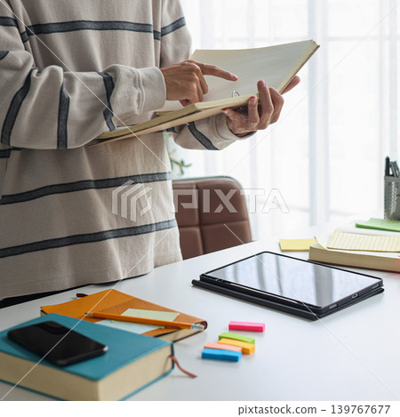 Man in casual cloth reading, studying at home. Man in casual cloth reading, studying at home. 139767677