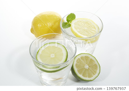 Cold lime water and lemon water placed against a white background Cold lime water and lemon water placed against a white background 139767937
