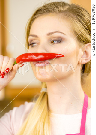 Woman holding chilli hot pepper Woman holding chilli hot pepper 139768056