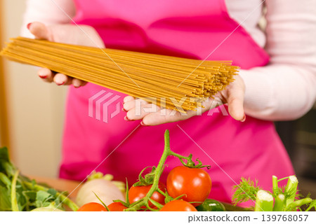 Woman holding long pasta 139768057