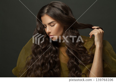 Beauty portrait of woman hair. Beautiful model with long curly hairstyle posing Beauty portrait of woman hair. Beautiful model with long curly hairstyle posing 139768106
