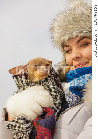 Woman hug warming her dog in cold day Woman hug warming her dog in cold day 139768158