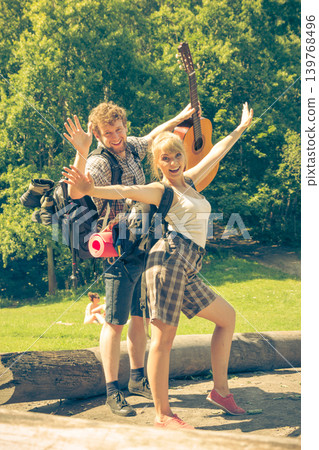 Happy tourist couple with guitar outdoor Happy tourist couple with guitar outdoor 139768496