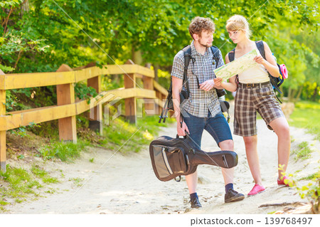 Hiking backpacking couple reading map on trip. Hiking backpacking couple reading map on trip. 139768497