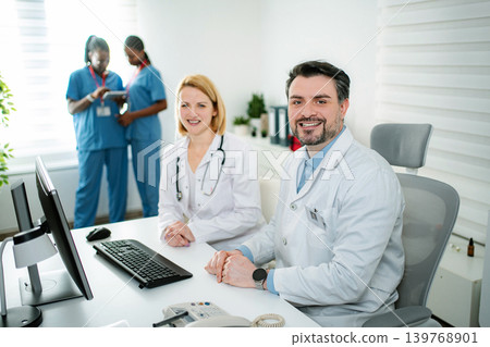 Medical team collaborating in clinic office smiling at camera Medical team collaborating in clinic office smiling at camera 139768901