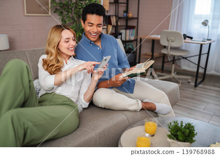 Young couple enjoying leisure time on sofa Young couple enjoying leisure time on sofa 139768988