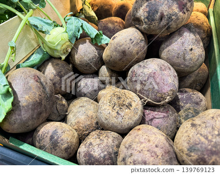 A close-up view of fresh red beet (beetroot) displayed at a market, stacked for sale in grocery. Beet background. 139769123