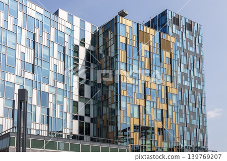 Modern building facade with colorful pixelated glass panels Modern building facade with colorful pixelated glass panels 139769207