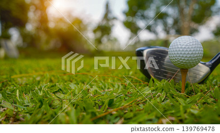 Golf clubs and balls on a green lawn in a beautiful golf course with morning sunshine. 139769478