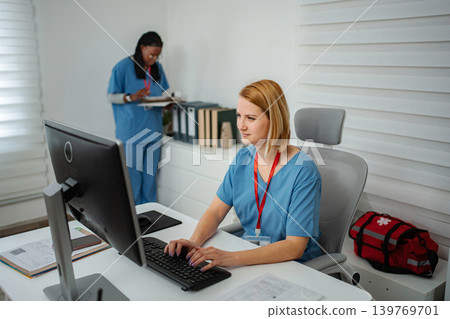 Healthcare staff working at desktop computer in clinic 139769701