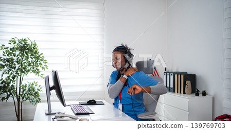 Healthcare worker experiencing neck shoulder pain at office desk Healthcare worker experiencing neck shoulder pain at office desk 139769703