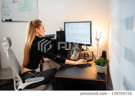 Woman working remotely at home office desktop setup 139769726