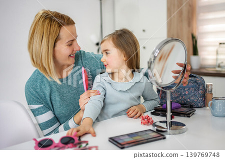 Mother and daughter bonding doing hair and makeup Mother and daughter bonding doing hair and makeup 139769748