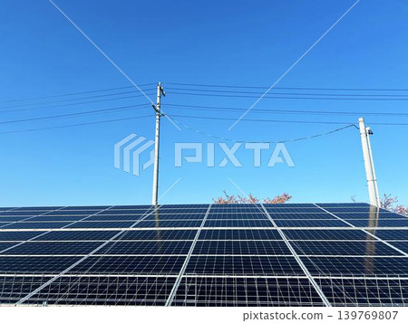 Solar panels, utility poles, and blue sky Solar panels, utility poles, and blue sky 139769807