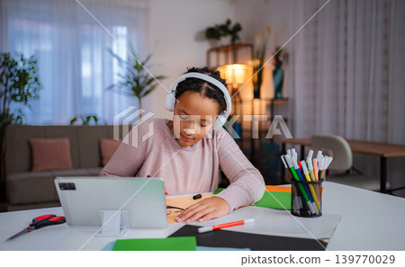 Young student learning from tablet and drawing with markers 139770029