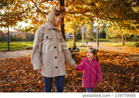 Mother and daughter enjoying walk in autumn park 139770088