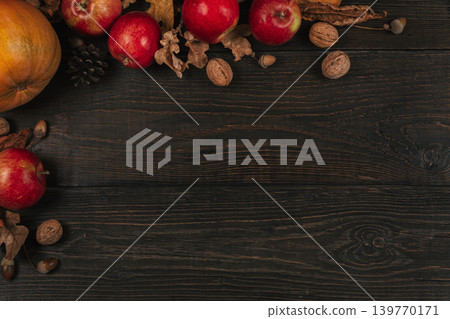 Autumn background with pumpkin, apples and nuts. Dark rustic wooden background. 139770171