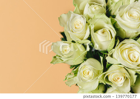 Romantic bouquet of cream roses on pastel peach background. 139770177