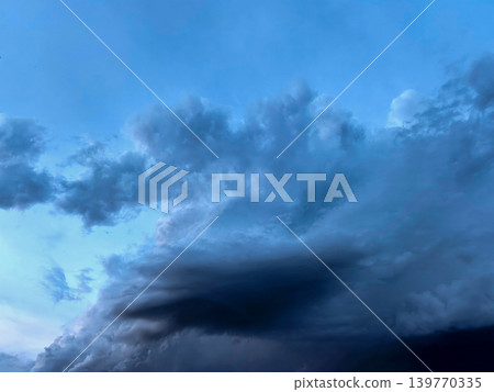 Blue Storm Cloud Formation Across Evening Sky Blue Storm Cloud Formation Across Evening Sky 139770335