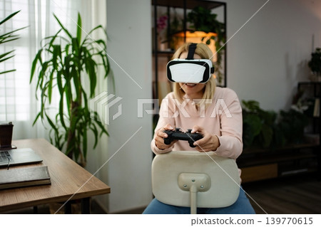 Engaging in Virtual Worlds from a Cozy Home Sanctuary with a Controller in Hand Engaging in Virtual Worlds from a Cozy Home Sanctuary with a Controller in Hand 139770615