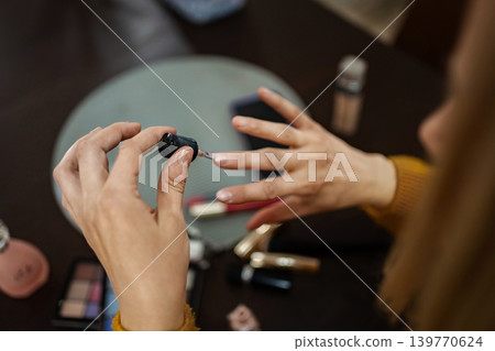 Creating elegance with nail polish in a cozy makeup space on a relaxed afternoon 139770624