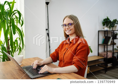 Professional woman working from home in a stylish modern office 139770949