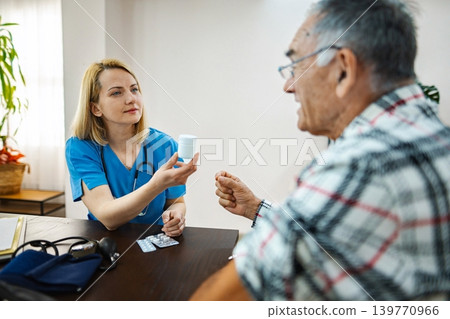 Doctor provides medication guidance to an older man Doctor provides medication guidance to an older man 139770966