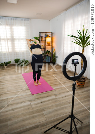Stretching and capturing moments in a serene home yoga studio 139771019