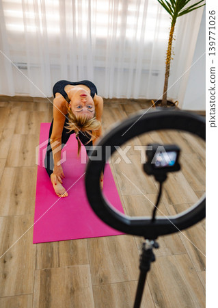Practicing yoga at home with creativity and focus in a serene space Practicing yoga at home with creativity and focus in a serene space 139771026