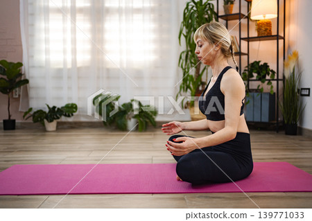 Meditative yoga practice in a serene indoor setting 139771033