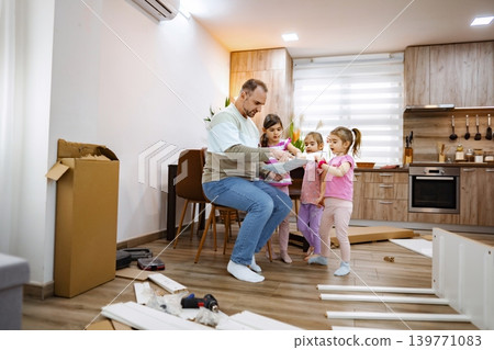 Father enjoys joyful moments with grandkids on a project 139771083