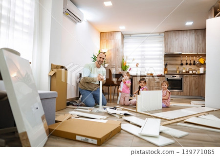 Building memories while assembling furniture in a cozy apartment space 139771085