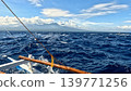 POV from an outrigger boat sailing over rough waves under a clear blue sky, with distant mountains in view. Dauin, Negros Island Region, Philippines POV from an outrigger boat sailing over rough waves under a clear blue sky, with distant mountains in view. Dauin, Negros Island Region, Philippines 139771256