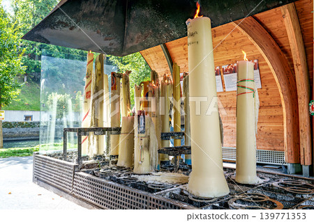 Specially crafted candles burning in Lourdes. One of the great traditions of Lourdes Specially crafted candles burning in Lourdes. One of the great traditions of Lourdes 139771353