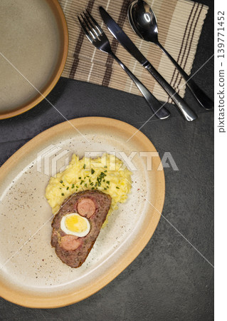 Typical Czech cuisine minced roast pork and beef with egg, sausage and mashed potatoes Typical Czech cuisine minced roast pork and beef with egg, sausage and mashed potatoes 139771452