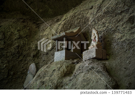 A small shrine and stone Buddha enshrined on a rock face A small shrine and stone Buddha enshrined on a rock face 139771483