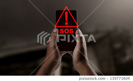 A person's hands hold a smartphone displaying a red SOS emergency alert and warning triangle in a dark environment, symbolizing a call for urgent help and safety notification A person's hands hold a smartphone displaying a red SOS emergency alert and warning triangle in a dark environment, symbolizing a call for urgent help and safety notification 139771604