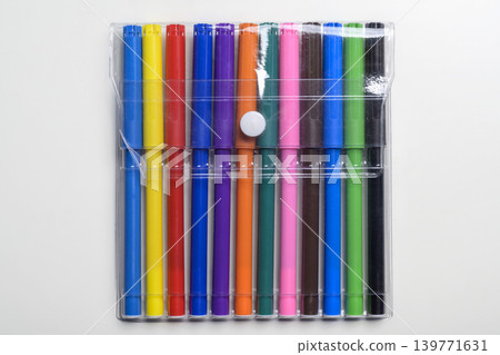 A collection of twelve vibrant multi-colored felt-tip markers in a transparent plastic pouch with a white button snap, isolated on a clean white background A collection of twelve vibrant multi-colored felt-tip markers in a transparent plastic pouch with a white button snap, isolated on a clean white background 139771631