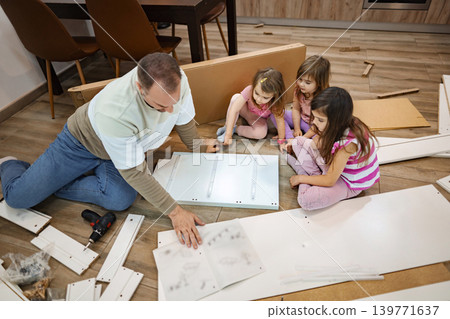 Creative assembly time with family in a cozy living room Creative assembly time with family in a cozy living room 139771637