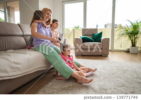 Joyful moments of family bonding in a bright living room Joyful moments of family bonding in a bright living room 139771749