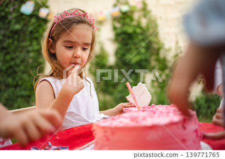 Sweet birthday moment with cake and friends at party Sweet birthday moment with cake and friends at party 139771765