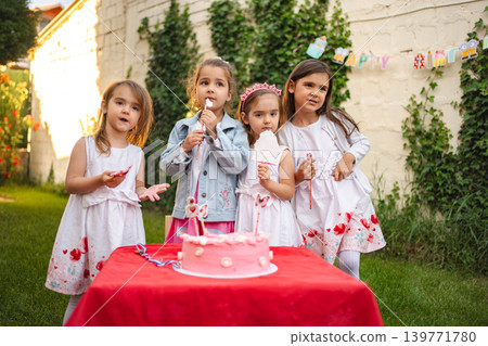 Joyful birthday celebration with cute children in garden Joyful birthday celebration with cute children in garden 139771780