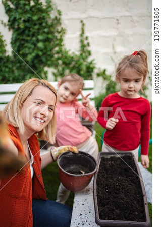 Family bonding through gardening in a sunny backyard 139771805