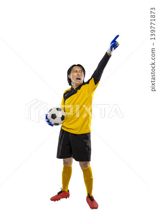 Professional Indonesian southeast asian soccer goalkeeper in a yellow uniform holding a ball and pointing upwards while shouting with passion, isolated on a white background Professional Indonesian southeast asian soccer goalkeeper in a yellow uniform holding a ball and pointing upwards while shouting with passion, isolated on a white background 139771873