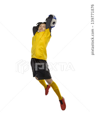 Professional Indonesian southeast asian soccer goalkeeper in yellow jersey jumping high to catch a football, action shot isolated on white background Professional Indonesian southeast asian soccer goalkeeper in yellow jersey jumping high to catch a football, action shot isolated on white background 139771876